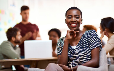 Canvas Print - My career suits my creative personality. Portrait of a confident young businesswoman sitting in an office.