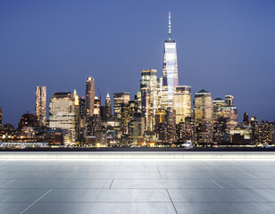 Empty concrete rooftop on the background of a beautiful blurry New York city skyline at evening, mockup