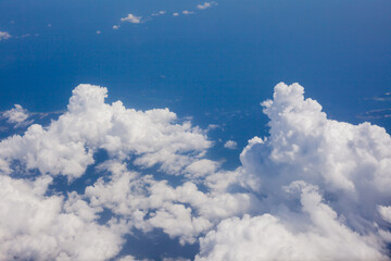Wall Mural - top view from fly, aerial view of clouds in blue sky