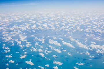 Wall Mural - top view from fly, aerial view of clouds in blue sky