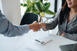 © Natee Meepian - Teamwork partnership meeting concept, Two confident Business shaking hands after discussing of trading contract and new projects for both companies.