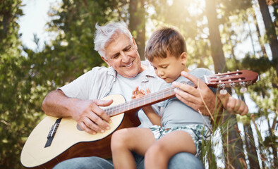 Sticker - Wanna have a go. Cropped shot of a handsome mature man teaching his grandson how to play the guitar while camping in the woods.