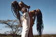 © Nicholas Felix/peopleimages.com - Nothing can break us down if we build each other up. Shot of two attractive young women holding hands against an African nature background.