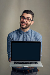 Aufkleber - Your business website would look great here. Studio portrait of a young man holding a laptop against a grey background.