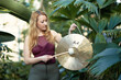 Yoga concept, meditation and sound therapy. Beautiful young caucasian woman performing tibetan gong music therapy.