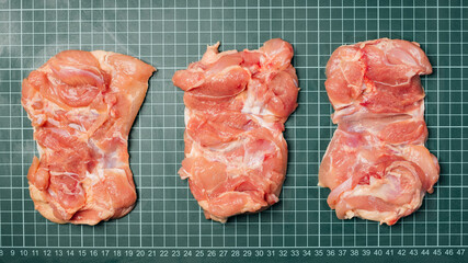 Wall Mural - Raw skinless boneless chicken thigh, for cooking.Chicken thigh,leg meat on a line board.