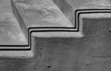 Two Shadows Cast On Cement Or Concrete Stairs Following The Contours Of The Steps To Right Angles Side View Of Steps Horizontal Format Backdrop Background Or Wallpaper Room For Type Content Or Logo 