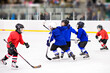 Children playing hockey on the ice arena