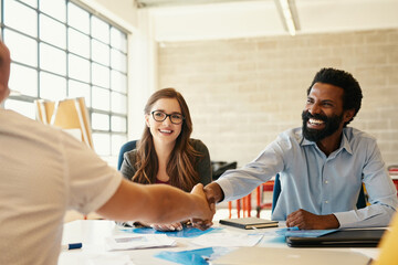 Aufkleber - Let the bond with creativity and business begin. Shot of creative employees shaking hands in a modern office.