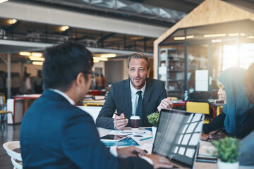 Canvas Print - Id love to hear your thoughts on this. Shot of a diverse group of businesspeople brainstorming around a table in their office.