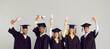 © Studio Romantic - Congrats, grad. Happy proud international multiracial multiethnic college or university students in graduate hats and robes standing on grey studio background and showing diplomas. Graduation concept