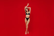 © ViDi Studio - Full body young slender brunette sexy hot caucasian woman 20s with perfect fit body wear black underwear hold hands up isolated on plain red background studio portrait. People female beauty concept