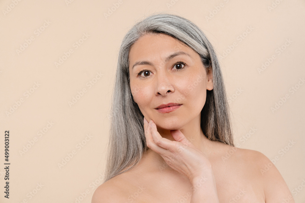Grey-haired mature middle-aged naked shirtless woman with clean pure