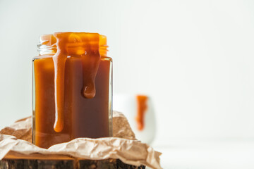 Wall Mural - Salted caramel in the glass jar on the white background