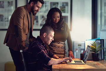 Poster - I was think along the lines of this example. Shot of a group of work colleagues working together on a laptop and exchanging ideas in the office.