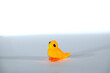 A small yellow chick. Plasticine bird on white background.