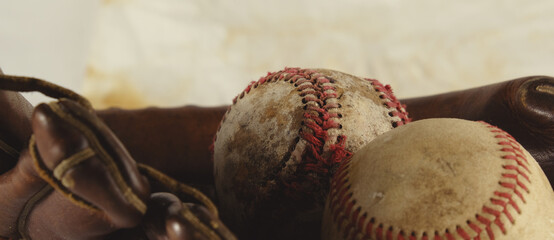 Canvas Print - Old baseball sport equipment with ball in glove close up and isolated on banner background.