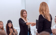© ASDF - business coach shaking hands with a new seminar participant