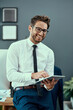 © Katleho Seisa/peopleimages.com - Youve got to make technology work for you. Portrait of a young businessman using a digital tablet in an office.