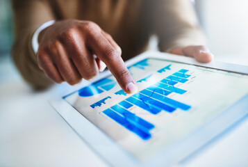 Poster - Reviewing the quantitative business data. Closeup shot of an unidentifiable businessman using a digital tablet in an office.