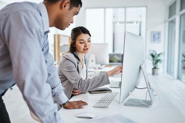 Wall Mural - technology that matches their target driven company. shot of a young businessman and businesswoman u