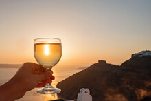 Hand Holding A Glass Of A Whitw Wine With A View