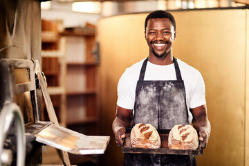 Aufkleber - If you want fresh then come to my bakery. Cropped shot of a male baker holding up freshly baked bread in his bakery.