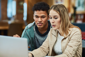 Wall Mural - This is the research Ive done so far.... Shot of two university students working together on a laptop at campus.