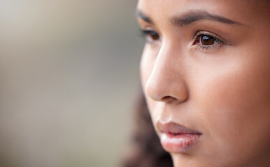 Poster - Keep your eyes on the goal. Closeup shot of a beautiful young woman looking thoughtful while standing outside.