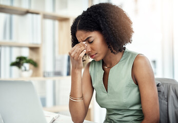 Poster - This headache is hampering her productivity. Cropped shot of an attractive young businesswoman suffering with a headache while sitting at her desk in the office.