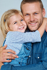 Wall Mural - For now theyre the best of friends. Portrait of an adorable little girl hugging her father around the neck.