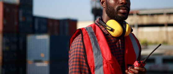 Engineer foreman, male African American, controls the inspection. Warehouse at container