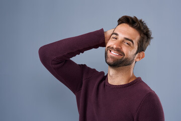 Poster - Handsomeness that just cant be ignored. Studio shot of a handsome and happy young man posing against a gray background.
