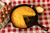 Fototapeta Tęcza - Cornbread in a Cast Iron Skillet with Eggs and Corn Flour on the Side