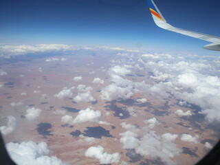 Wall Mural - airplane flying over the clouds