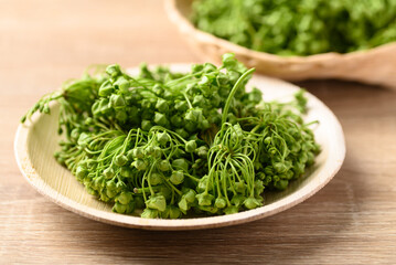 Wall Mural - Dregea volubilis flower in natural plate, Edible flower from local farmer market in summer season, Northern of Thailand