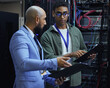 © Siphosethu Fanti/peopleimages.com - Going over the diagnostic report. Cropped shot of two male IT support agents working together in a dark network server room.