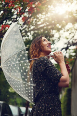 Aufkleber - She loves all the elements of nature. Cropped shot of a beautiful young woman walking in the rain outside.