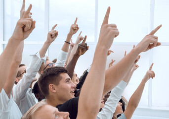 Poster - cropped image of a group of young people pointing up