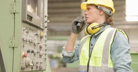 Wall Mural - In a factory, a worker presses buttons on a CNC machine control board. In a steel factory, a professional male technical engineer works in front of a machine 