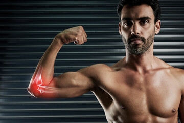 Wall Mural - Get pumped but dont overdo it. Studio portrait of a muscular young man flexing his bicep with cgi highlighting his elbow.