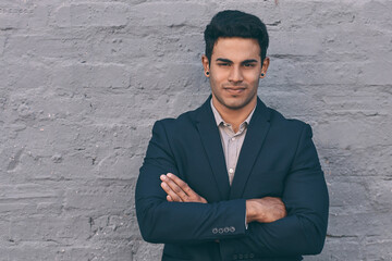 Aufkleber - Business is what I do best. Portrait of a handsome young businessman standing against a face brick wall with his arms folded.