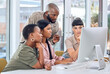 © Kay A/peopleimages.com - Everyone is striving towards one unified goal. Shot of a group of businesspeople discussing something on a desktop.