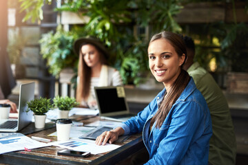 Poster - Success comes when you think outside the box. Portrait of a young designer having a meeting with her colleagues at a coffee shop.