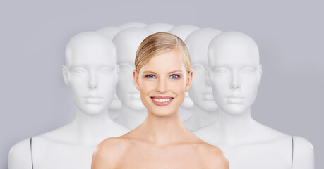 Bring your beauty to life. A young woman standing amongst a group of mannequins.