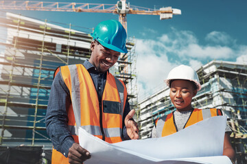 Poster - Running a job site is a joint effort. Shot of a young man and woman going over building plans at a construction site.