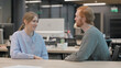 © stockbakers - Woman Talking to Young Man in Office