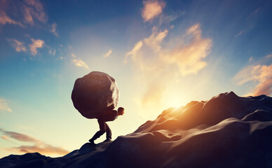 man carrying haeavy stone, boulder uphill.