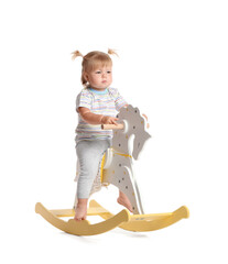 Sticker - Adorable baby girl with rocking horse on white background