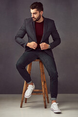 Poster - His confidence is the first thing everyone notices. Studio shot of a handsome young man posing against a dark background.